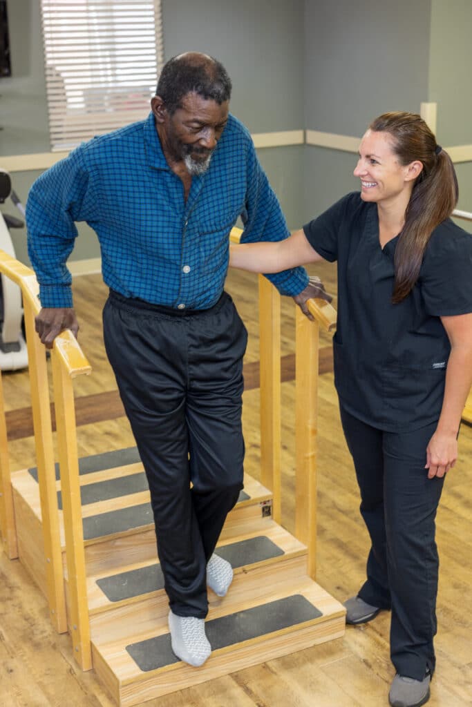 Physical therapist with patient on stairs at Linley Park