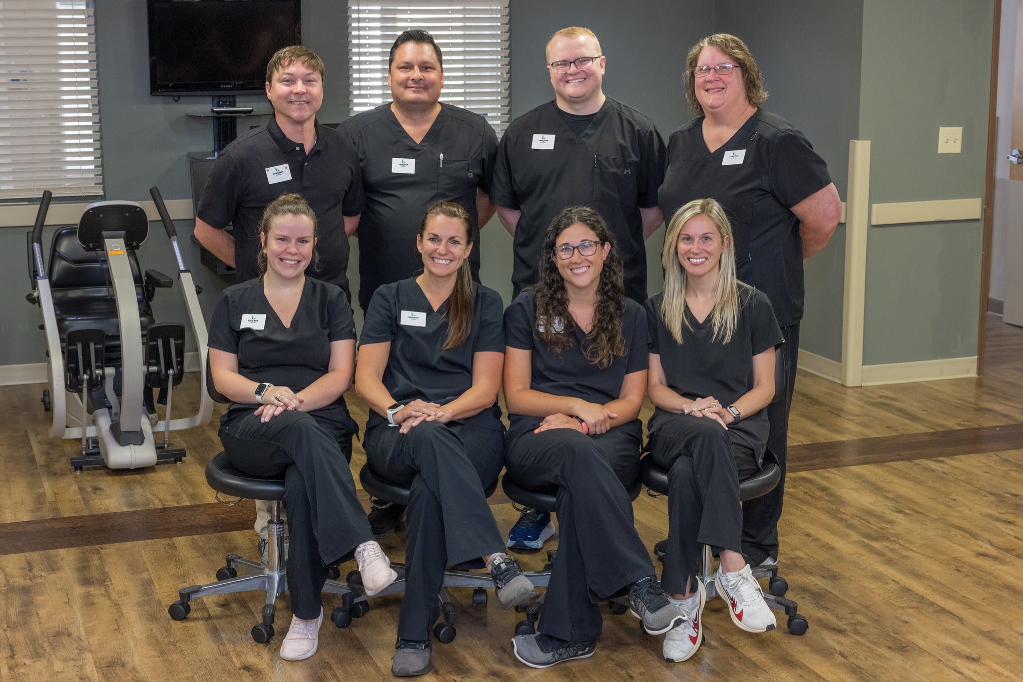 Eight physical therapists posing in gym at Linley Park